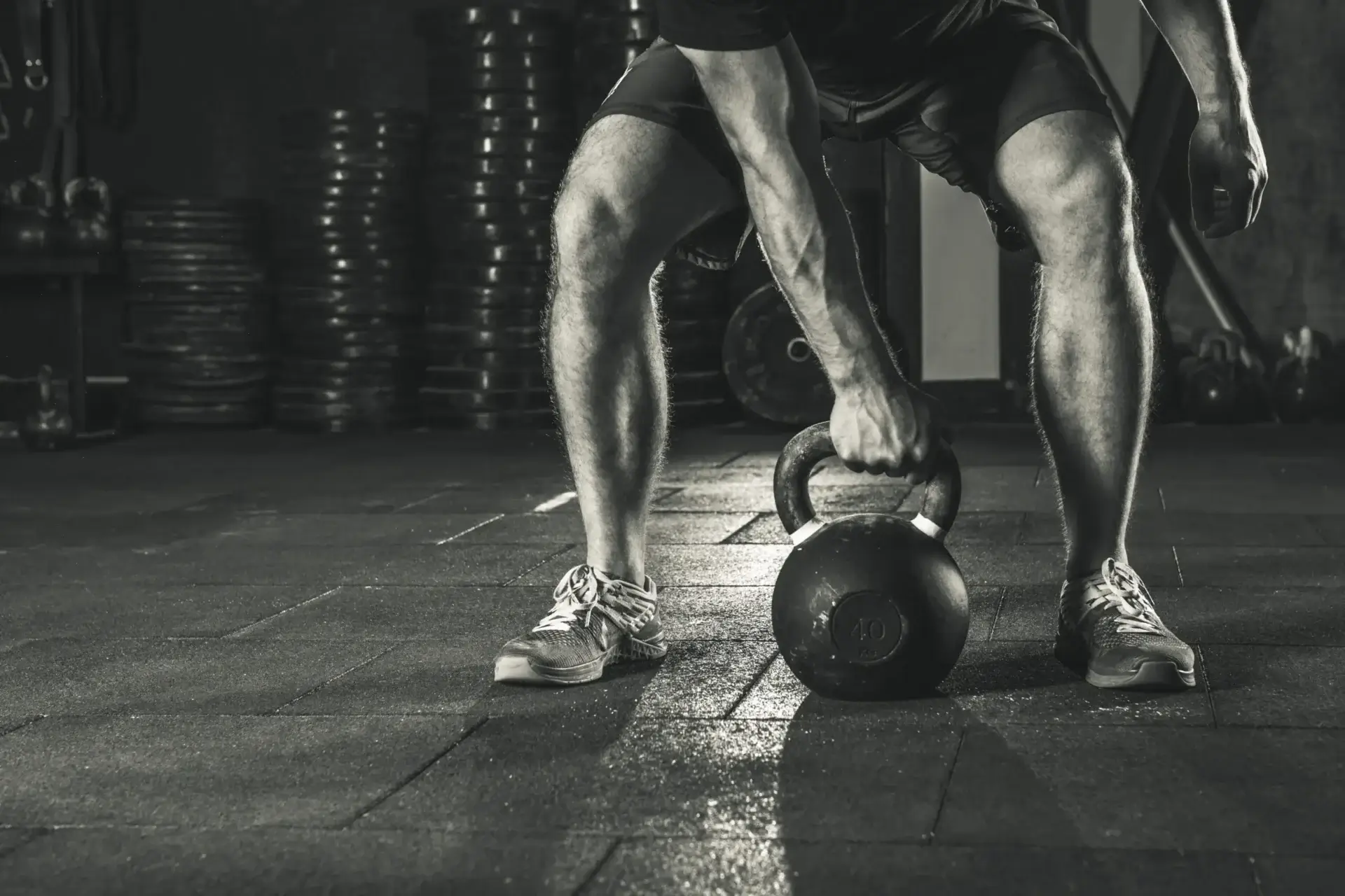 Close-up of legs holding a kettlebell